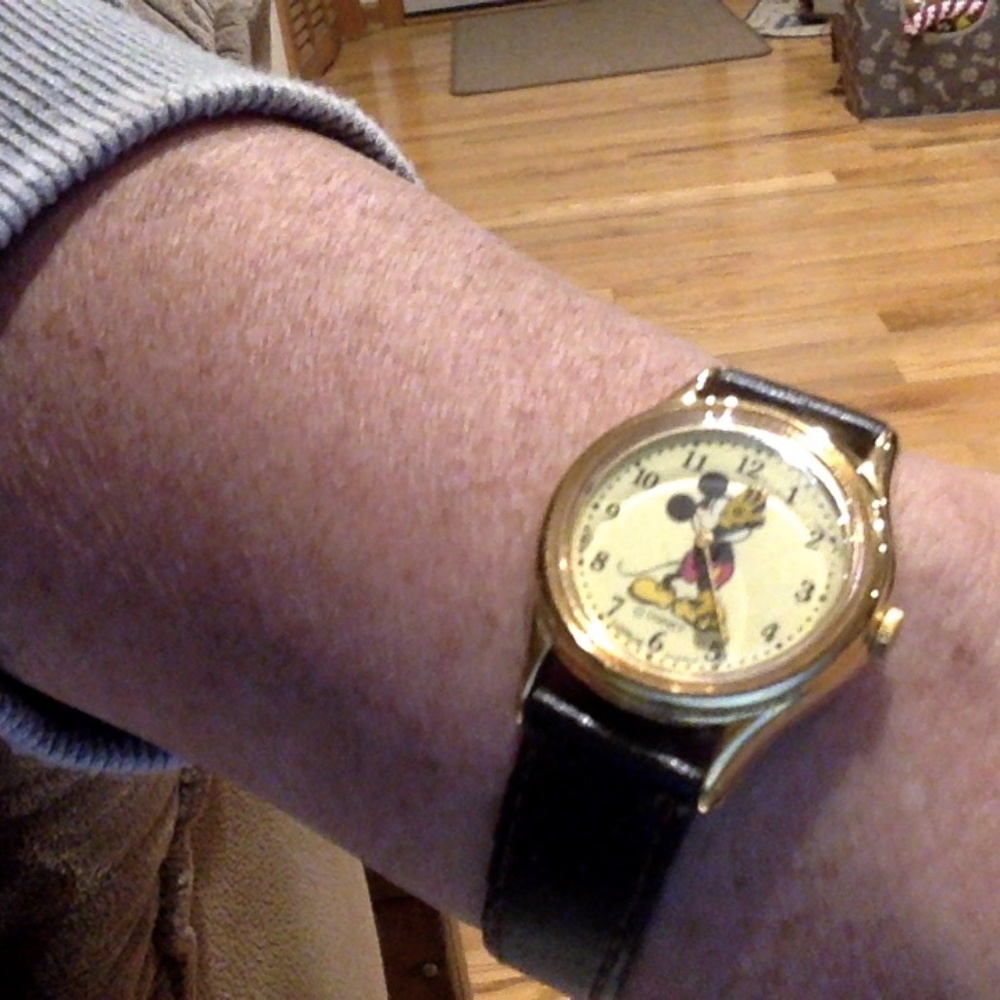Vintage Mickey Mouse Lotus watch with black leather band.